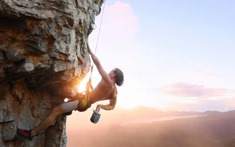 Risky rock climbing picture of a young man for instagram