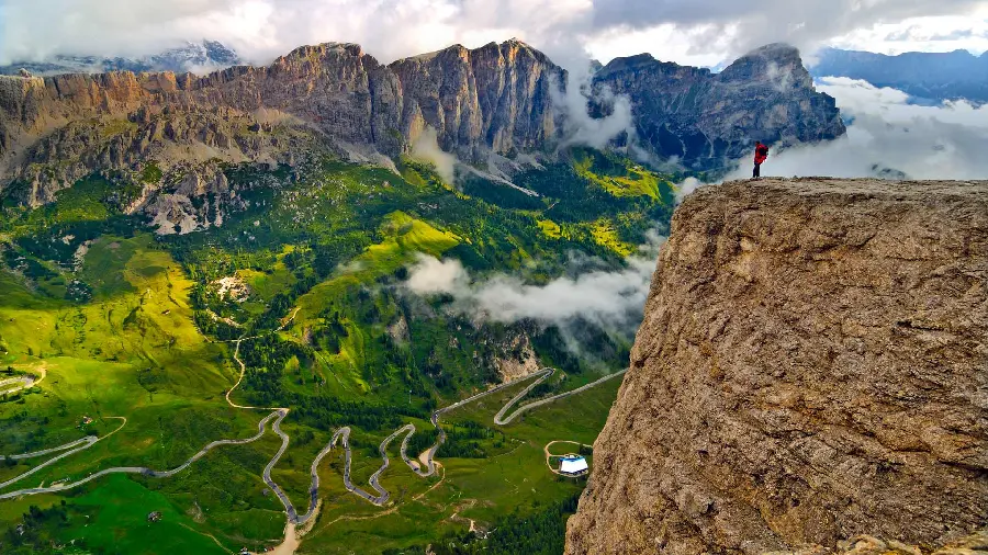 A pleasant picture of a climber on top of a high mountain with a natural range