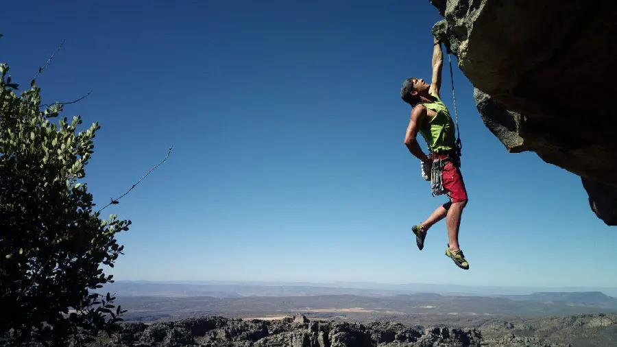 Dangerous scene of a man hanging from a mountain in excellent full hd quality