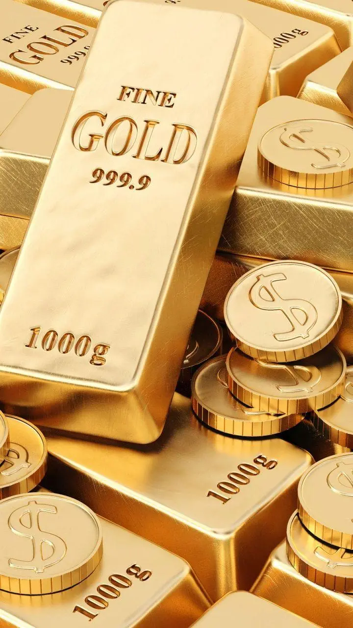 Stock image of gold bars next to gold coins