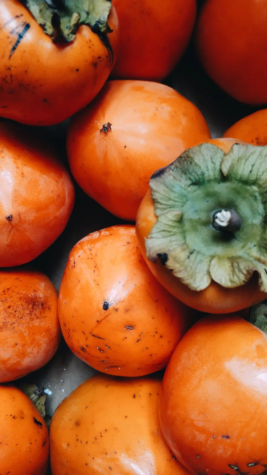 A macro and close-up photo of a beautiful autumn fruit persimmon