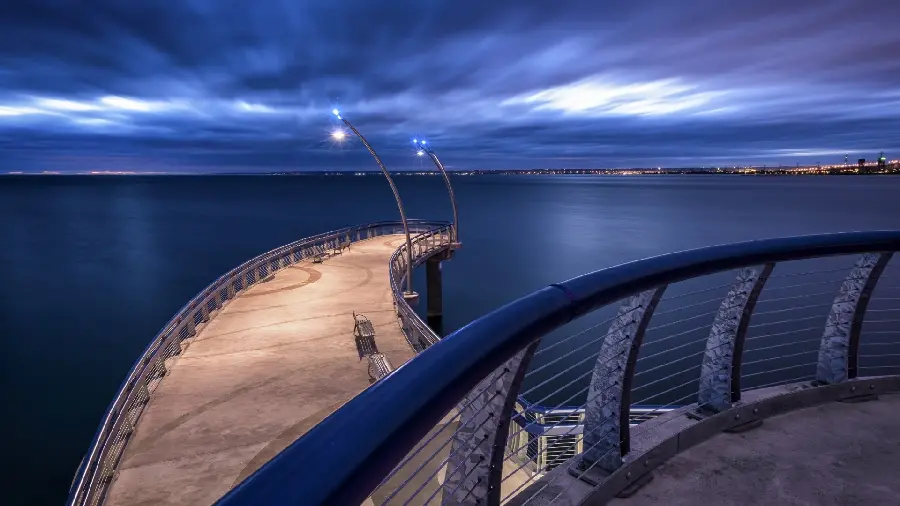 Wallpaper of a wooden bridge over the sea at night and a bright sky
