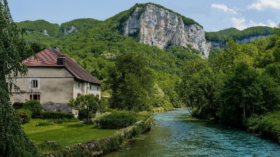 Image of a cottage in a lush and relaxing forest and mountain 
