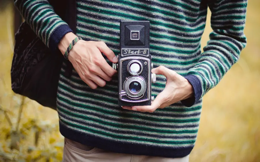 Attractive and stylish picture of a hand with a camera, especially for photographers' profiles and wallpapers