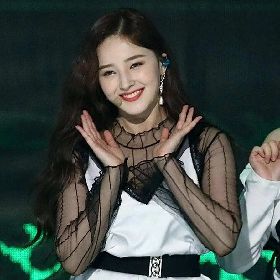 Download a pleasant background image of Nancy with a charming smile in a concert