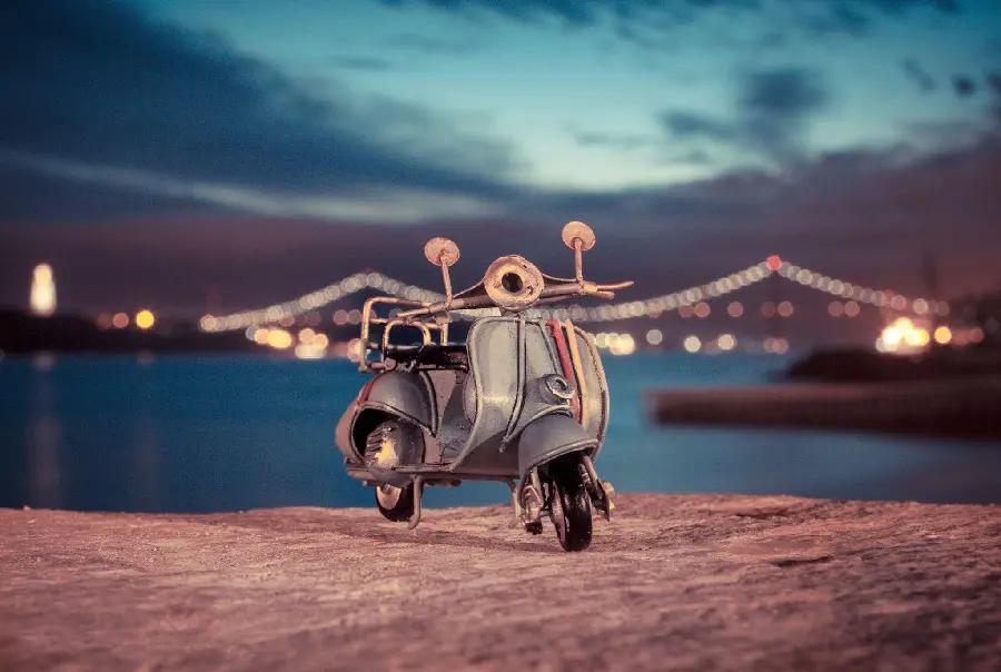 Laptop screen photo of a miniature and fantasy engine on a dirt road 