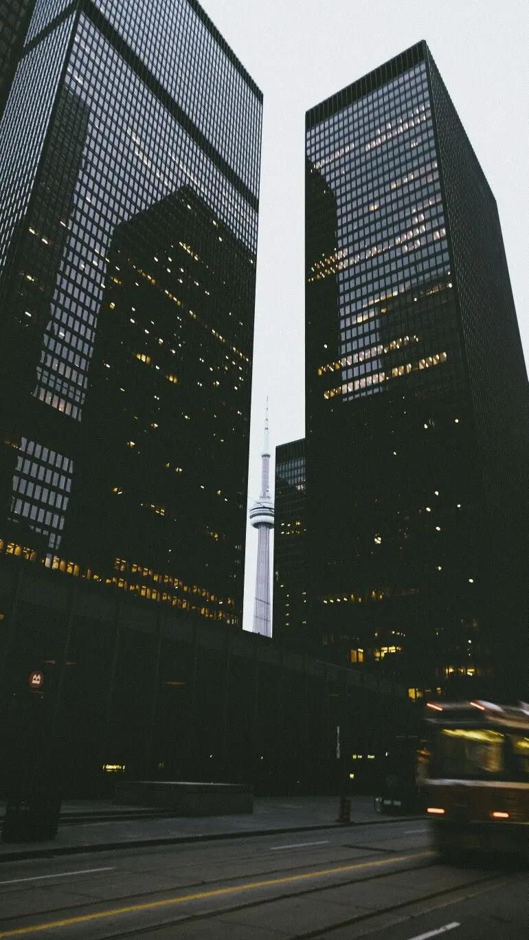 Download a very beautiful image of two tall buildings with bright lights 