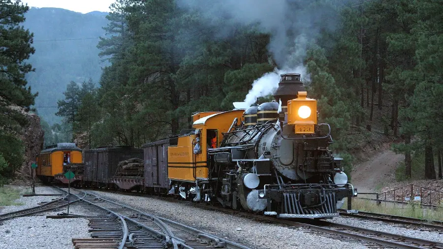 Background of a beautiful yellow-black locomotive moving on the rails