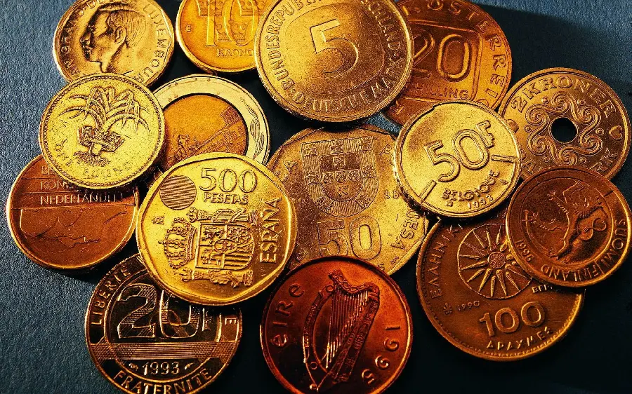 High-quality photo of a number of gold coins on a dark background 