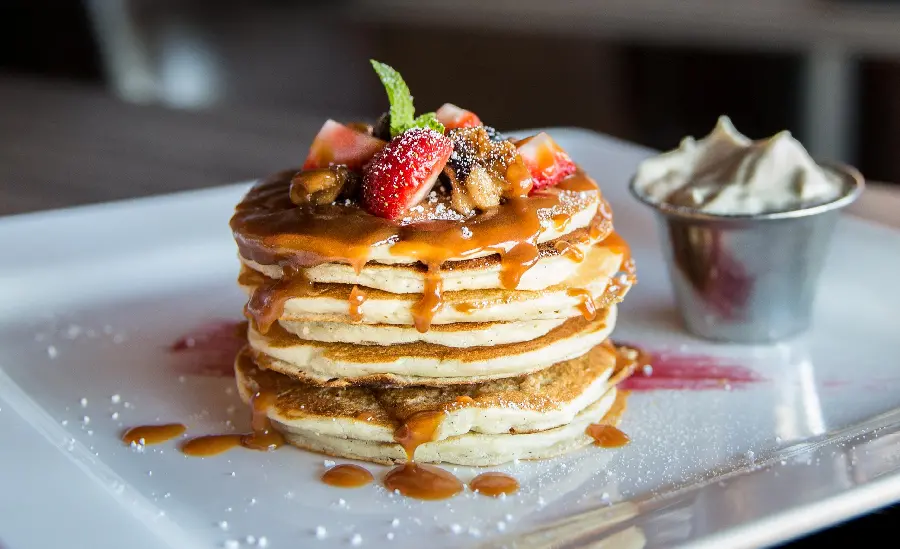 Download free photo of stylish decorated pancakes with snacks