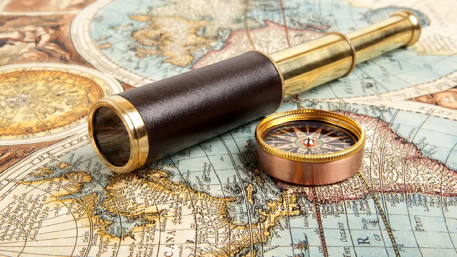 Profile photo of an old telescope on a paper map of the world in HD quality