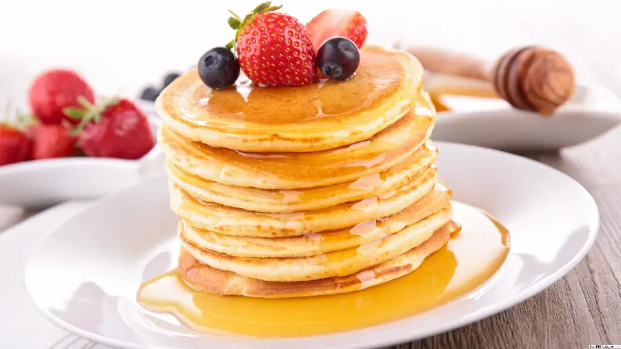 Image of delicious pancakes decorated with strawberries and blueberries 