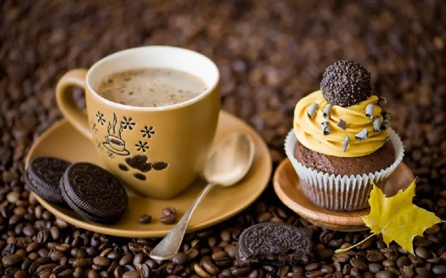 Interesting and beautiful wallpaper of a yellow cream cupcake and delicious coffee