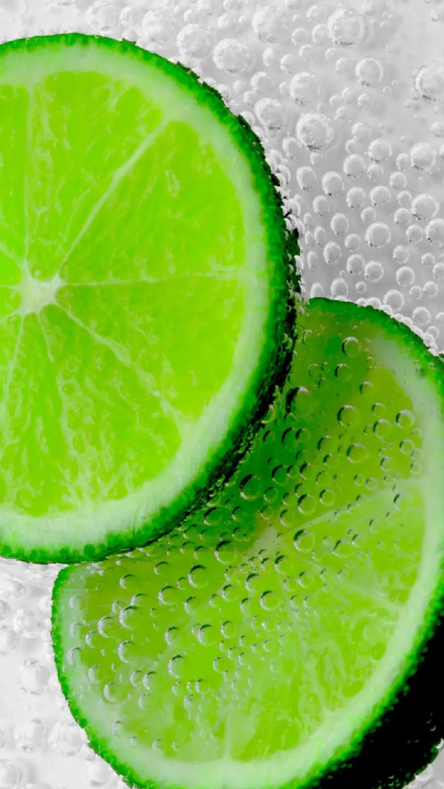 Beautiful and interesting background image of green lemon with water drops
