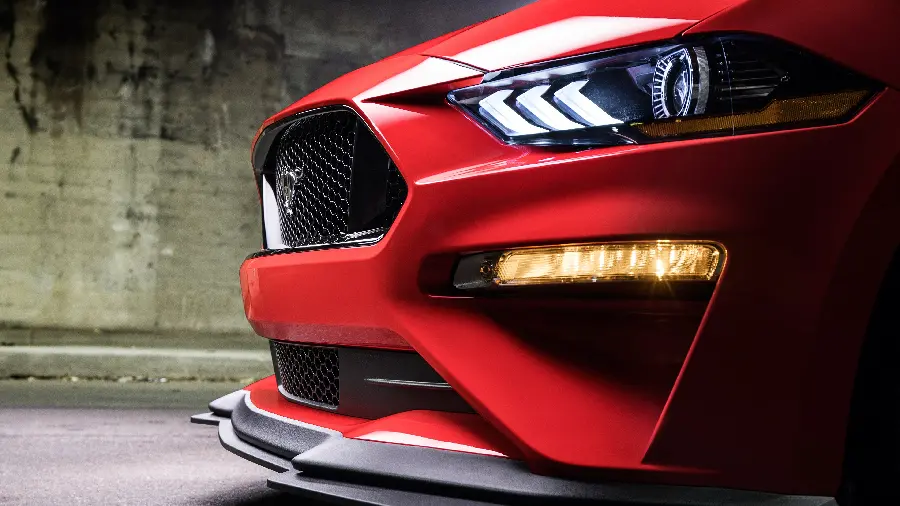 Stock photo of the front of a spectacular red high-end car with long headlights