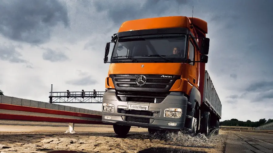 Photo of a beautiful orange Mercedes Benz Actros truck equipped with many features
