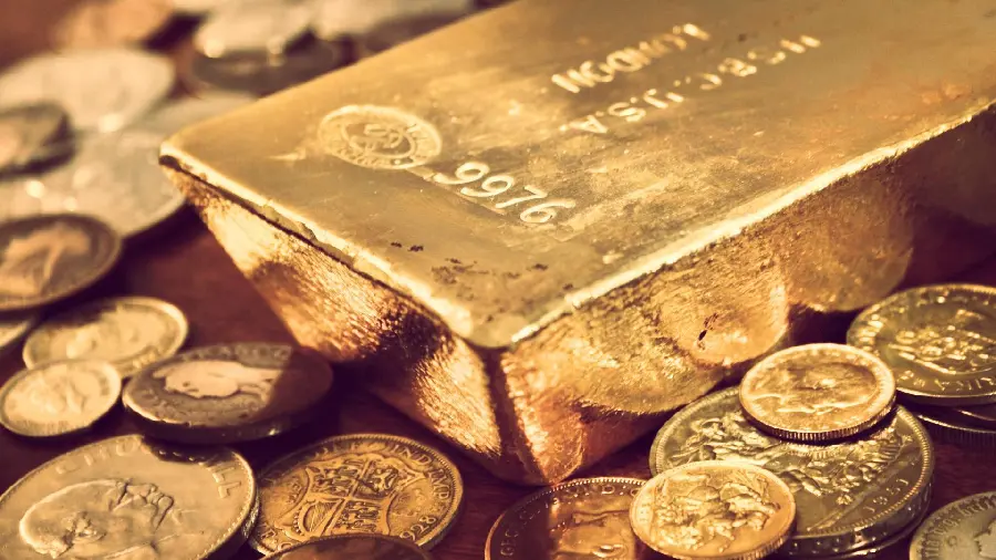 Wallpaper of a gold bar among a pile of gold coins suitable for a phone background 