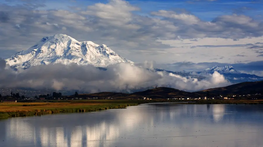 Download a dreamy wallpaper of a lake and white mountains