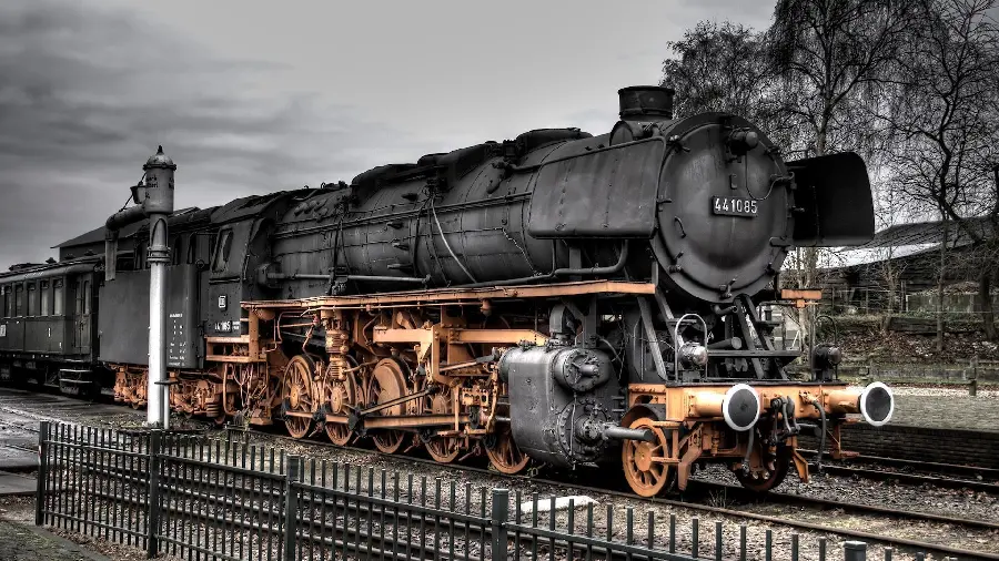 A cool black locomotive wallpaper with gold wheels for your desktop