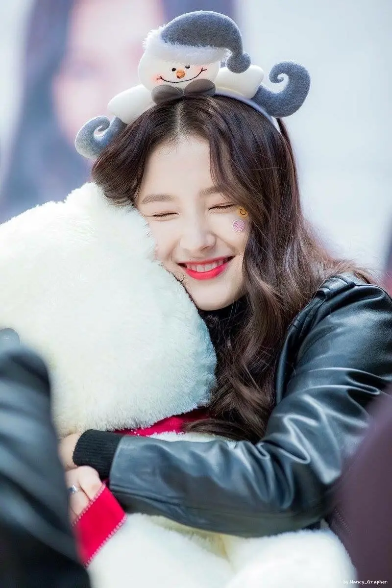 Funny photo of Nancy, the Korean singer, with a white doll in her arms