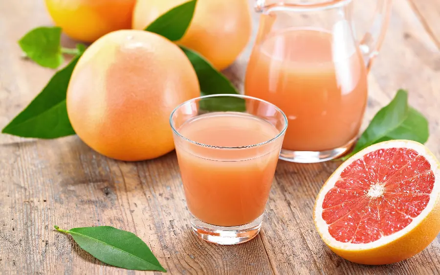A beautiful image of a grapefruit and its nutritious and useful juice