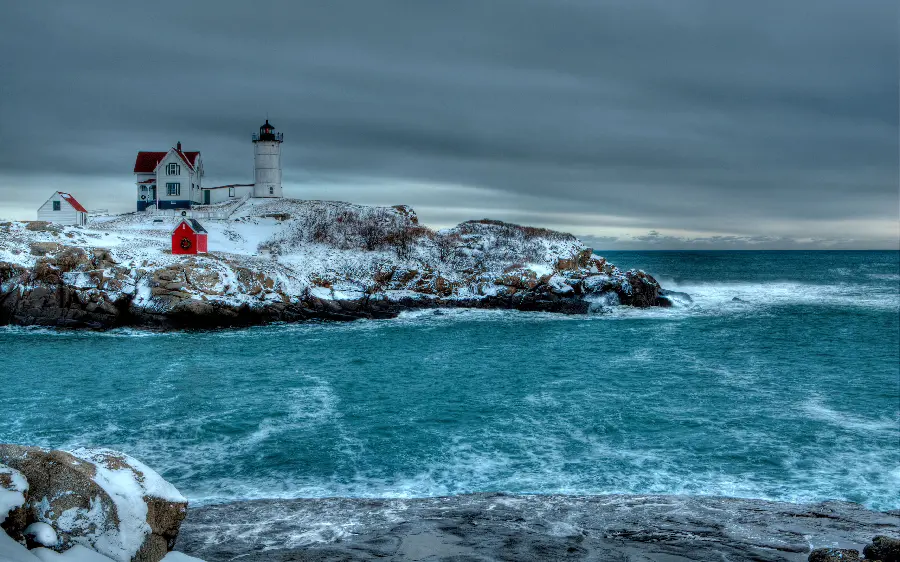 A dreamy background of a clear blue sea and a watchtower and a house on a cliff