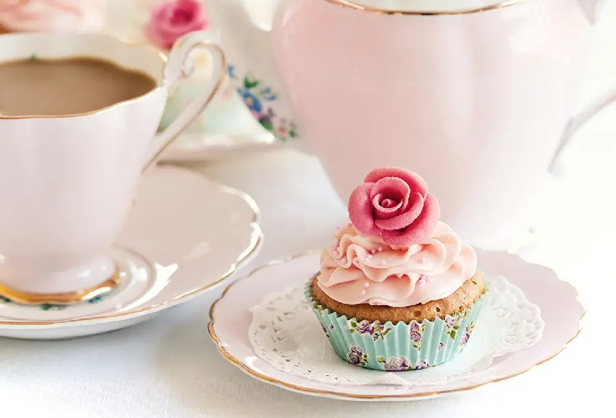 Beautiful and spectacular photo of a delicious pink cupcake and a beautiful flower on it 
