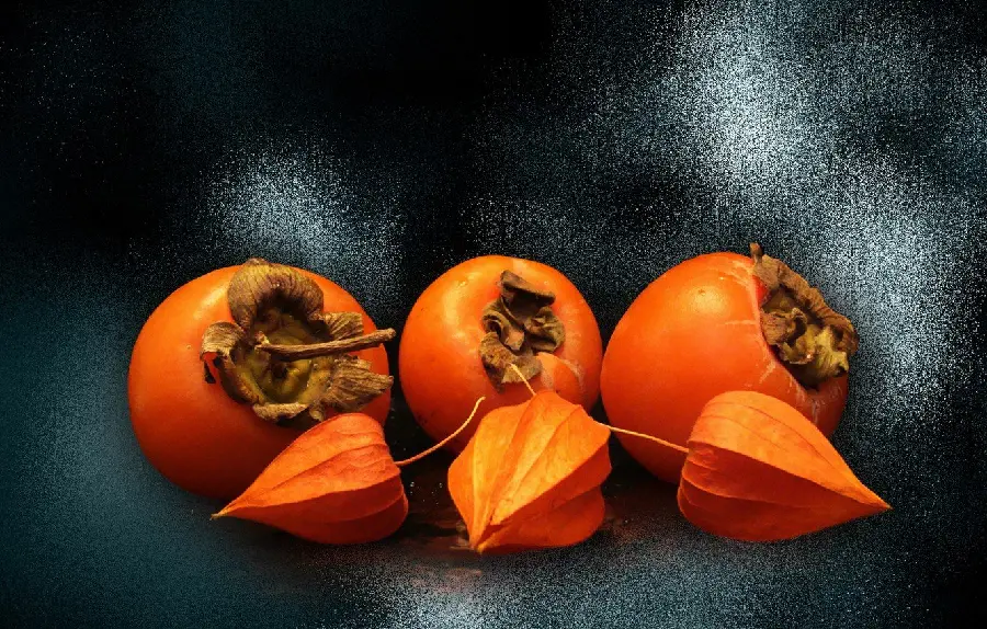 Wallpaper photo with black leather background of persimmons
