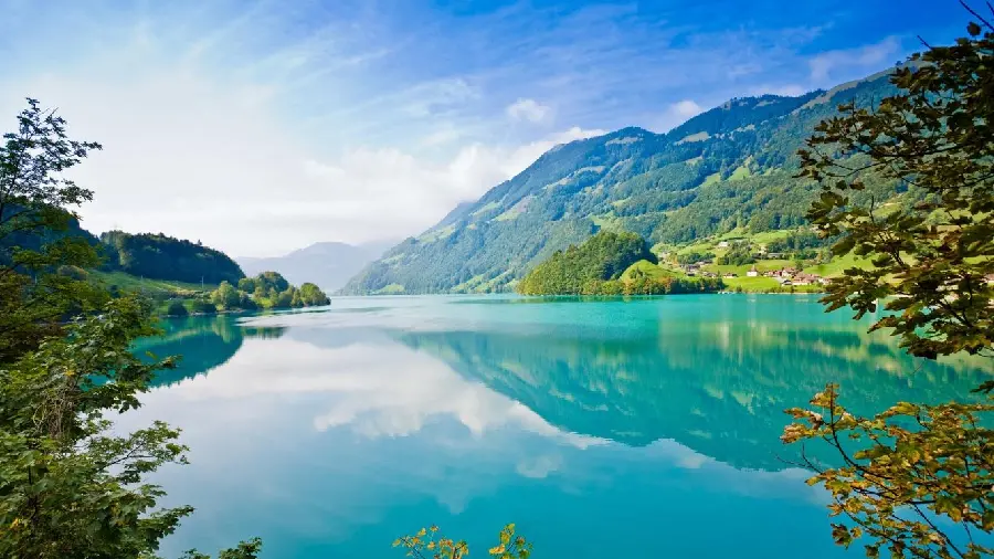 Profile image of a blue valley and tall mountains and trees