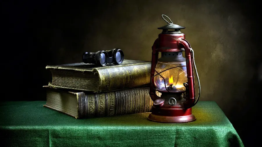 Artistic image of a book and a lantern on a table suitable for creating a photo caption in the Inshot program