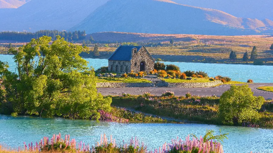 Sacred wallpaper of a stone church in the middle of nature and the blue sea