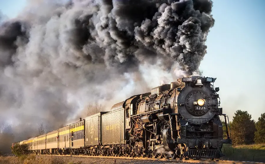 The most mysterious picture of an old locomotive with a lot of steam for Instagram