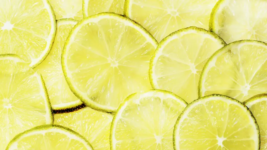Download background photo of thin slices of lemon on top of each other