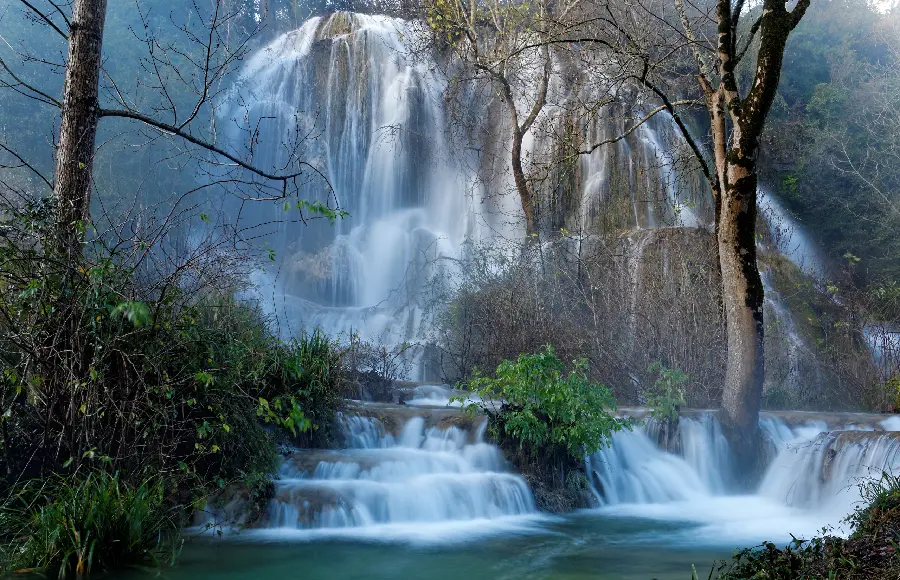 Amazing and unique photo of a tall waterfall in the heart of nature 