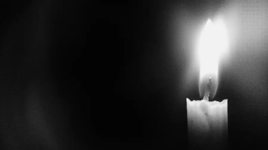 White candle image on black background for condolences 