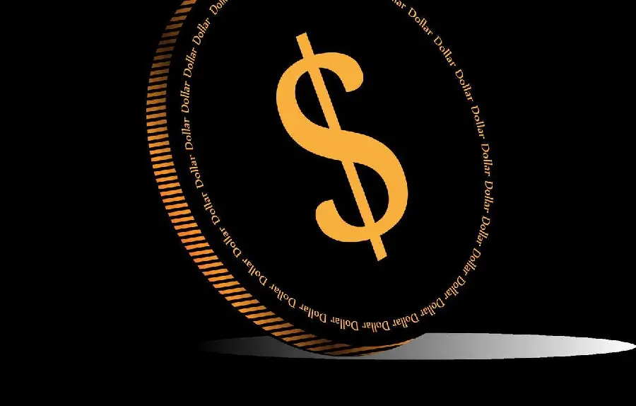 Image of an old coin with a black background with the US dollar symbol 