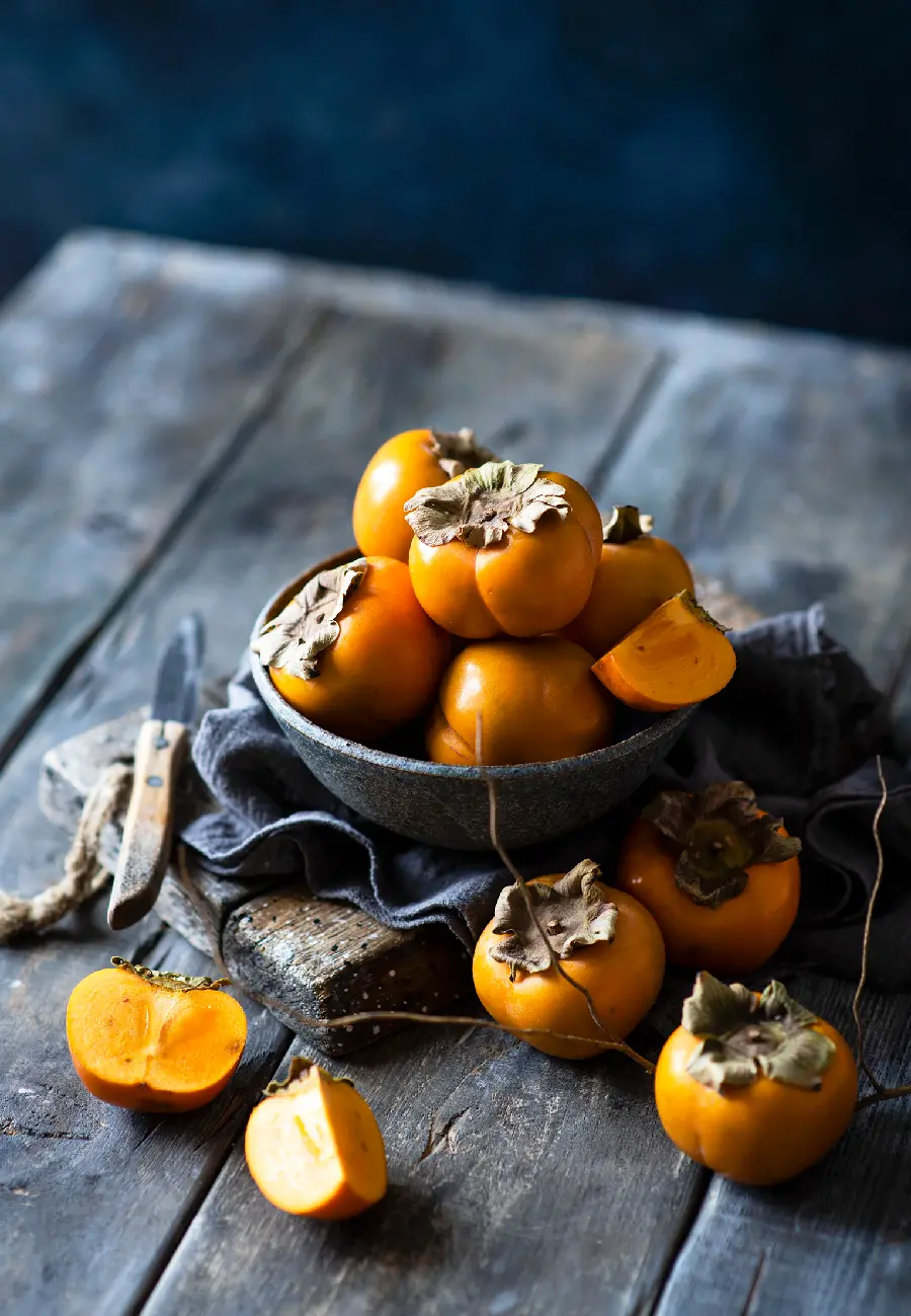 A charming and high-quality photo of a basket full of persimmons for painting