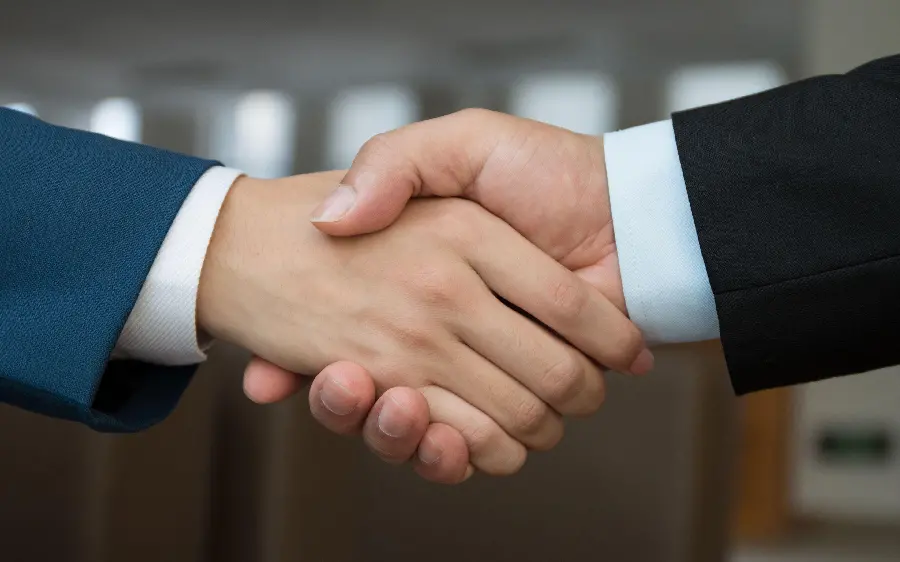 New photo of men shaking hands is not suitable for use in student and work projects 