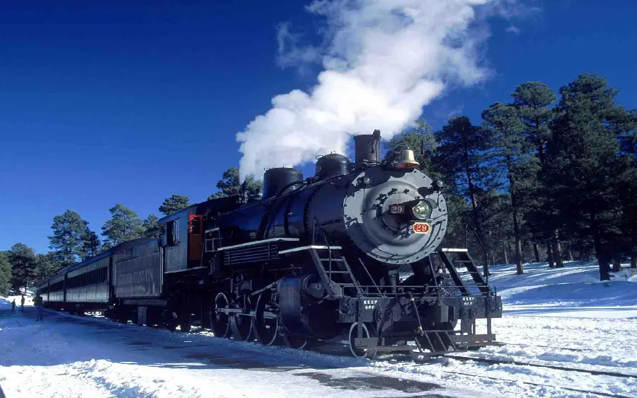 Background photo of an old black locomotive in winter snow suitable for laptops