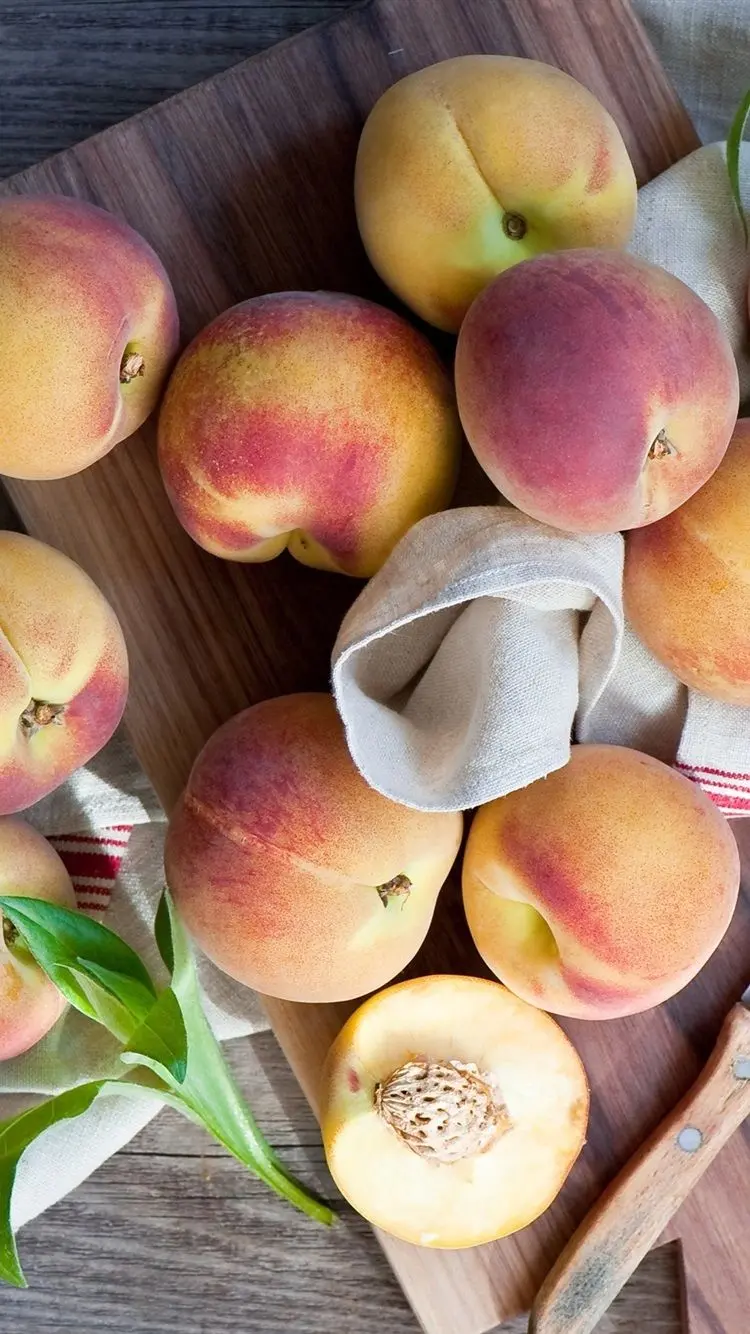 Admirable artistic frame of a whole and halved peach fruit for advertising