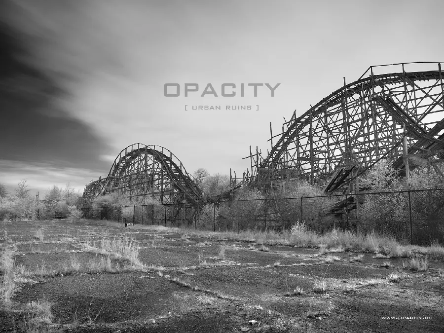 Black and white and scary image of an abandoned and rotten roller coaster