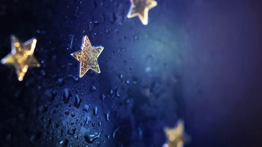Download wallpaper of a charming star on the glass with dew drops