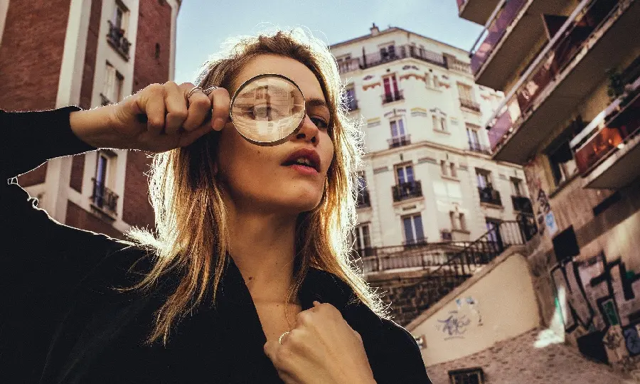  Attractive image of Magnifying glass in front of a girl's eye 
