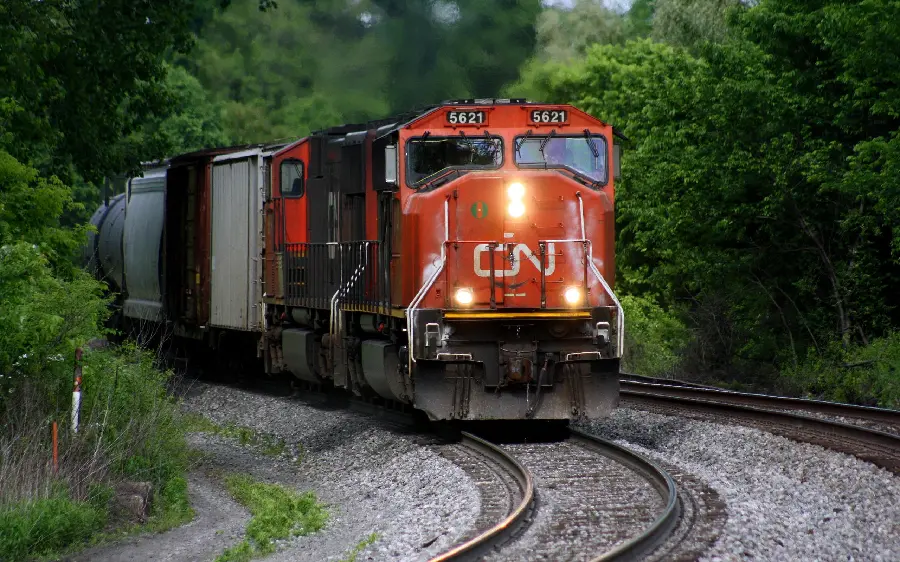 Cool wallpaper of a giant red locomotive moving on a railway track
