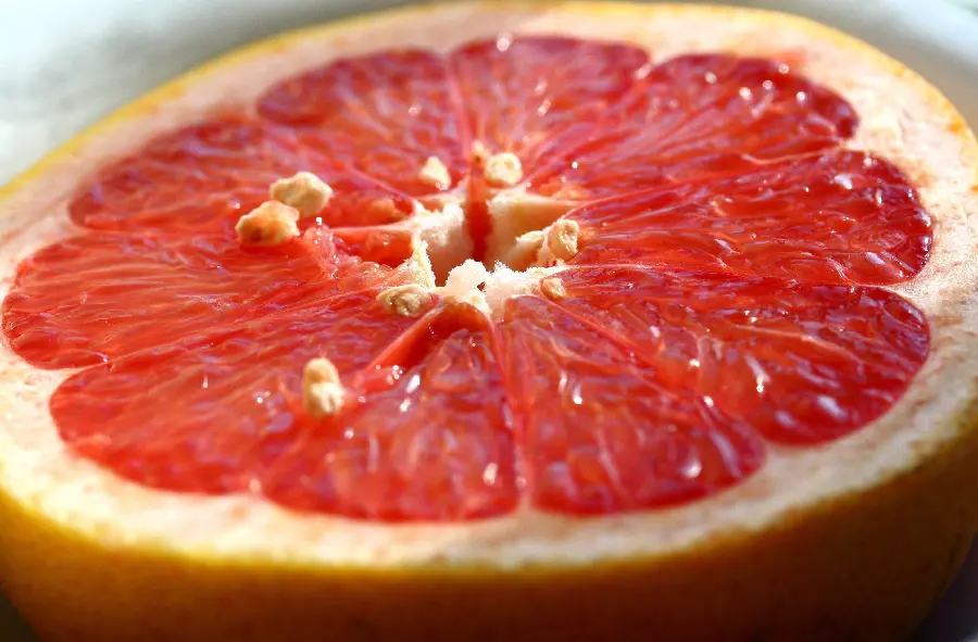 A close-up macro image of a delicious and colorful grapefruit