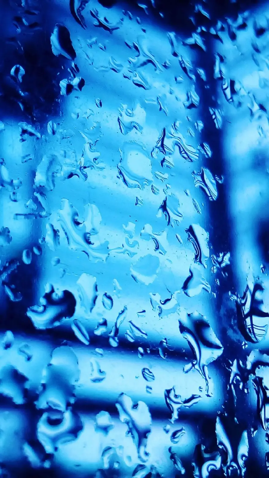 Dreamy blue background With liquid drops on glass design for mobile 