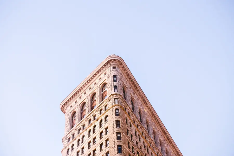 Minimalist wallpaper with tall building design on blue sky background