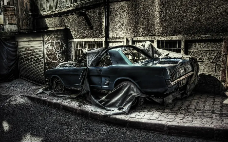 Awesome edited image of a worn-out car in the ruined alleys of the city