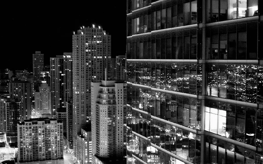 Background of shiny black and white glass skyscraper buildings in grayscale