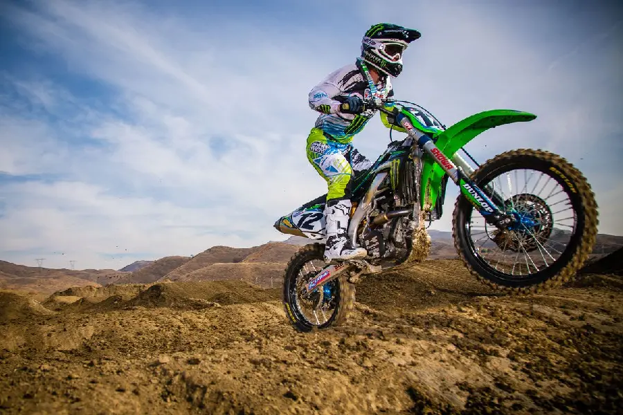 Motocross Background on a Dirt Track with a Speeding Kawasaki Motocross